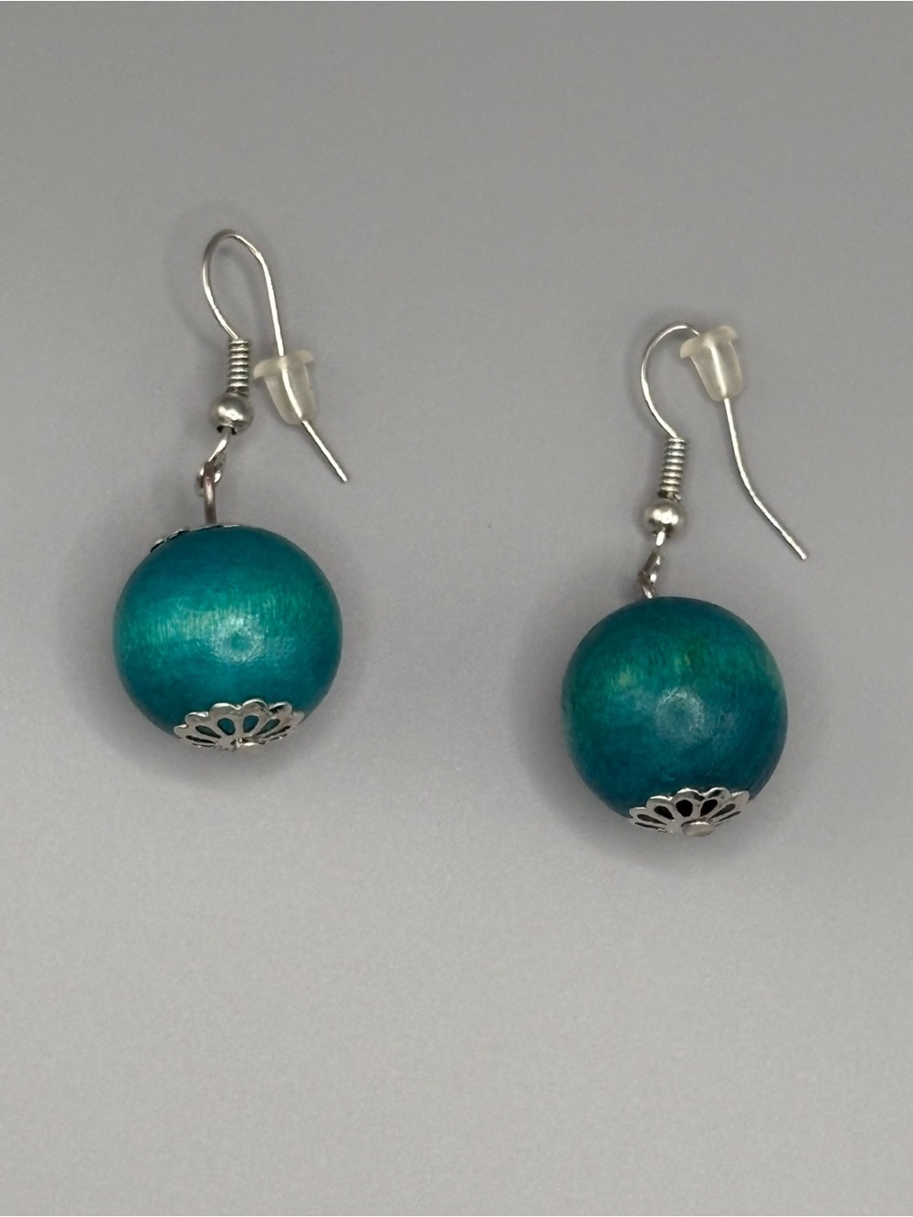 Bohemian theme round teal colored wooden dangle earrings